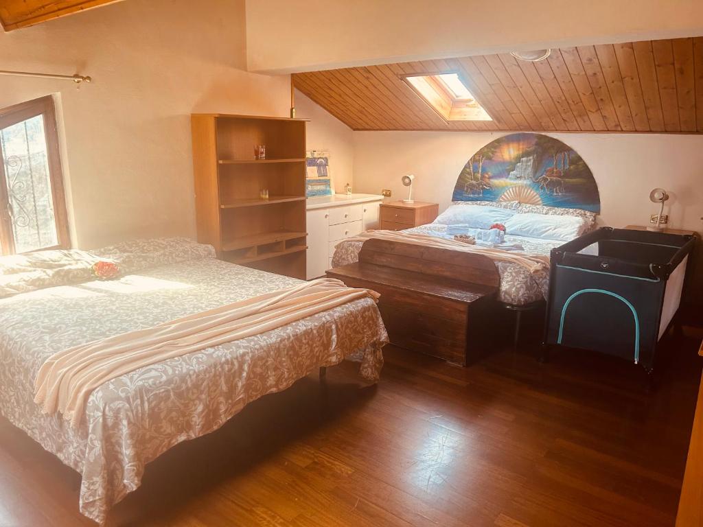 a bedroom with two beds and a desk in it at PERLA Bianca DELLE 5 TERRE in La Spezia
