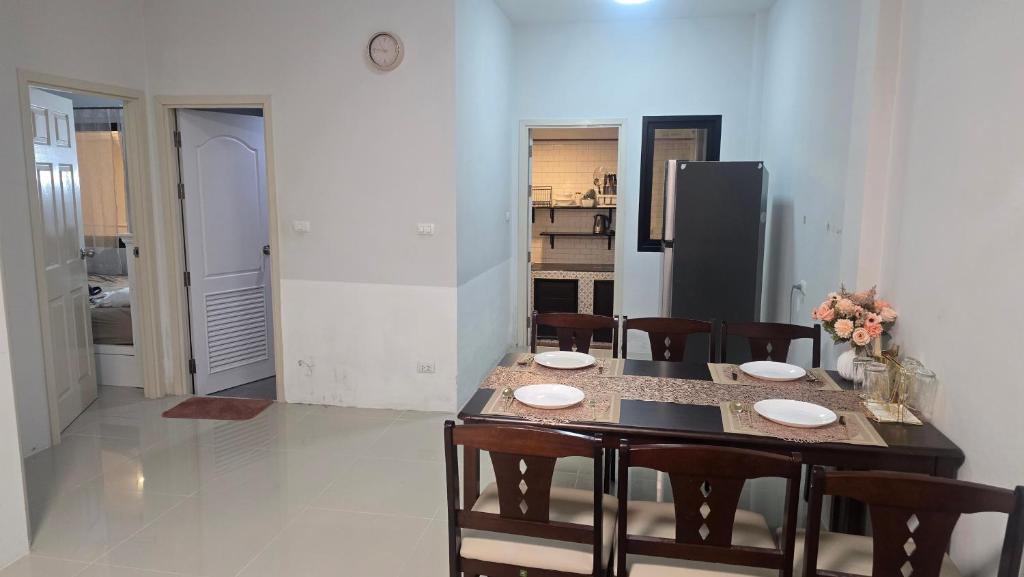 a kitchen and dining room with a table and chairs at joyful House Naiyang 238 in Nai Yang Beach