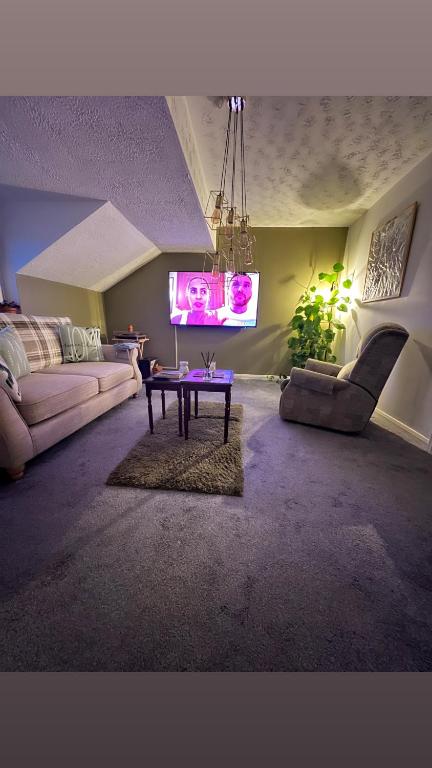 a living room with a couch and a table at The Cosy Cumbrian Homestay in Penrith