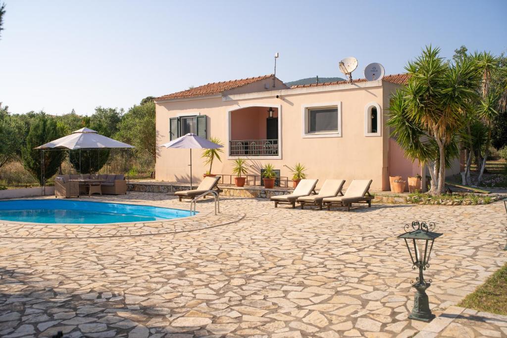 a villa with a swimming pool and a house at Villa Argias Halikounas in Halikounas