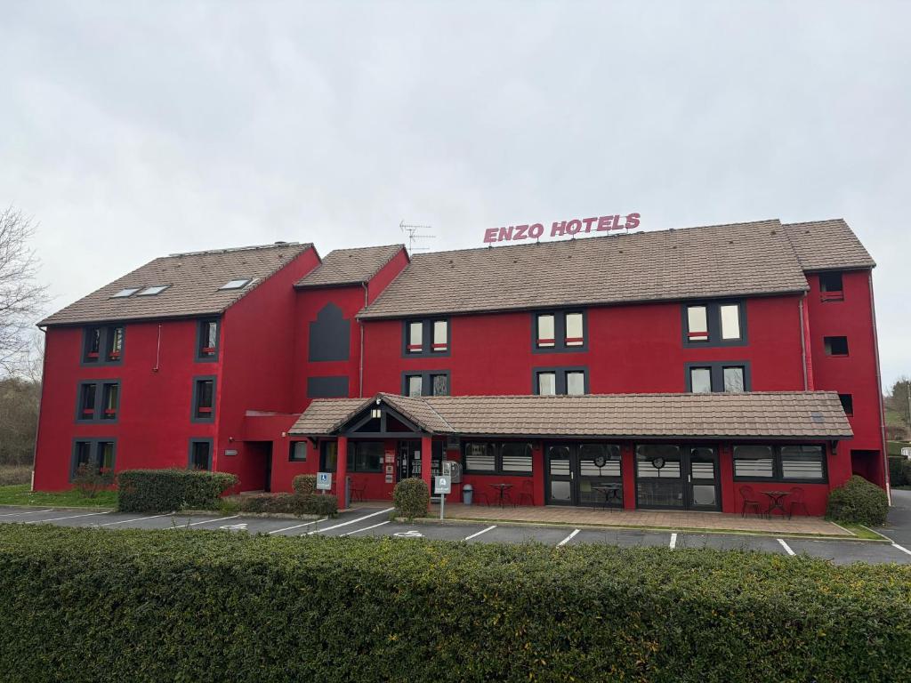 a large red building with a red hotel at Enzo Hotels Vierzon by Kyriad Direct in Vierzon
