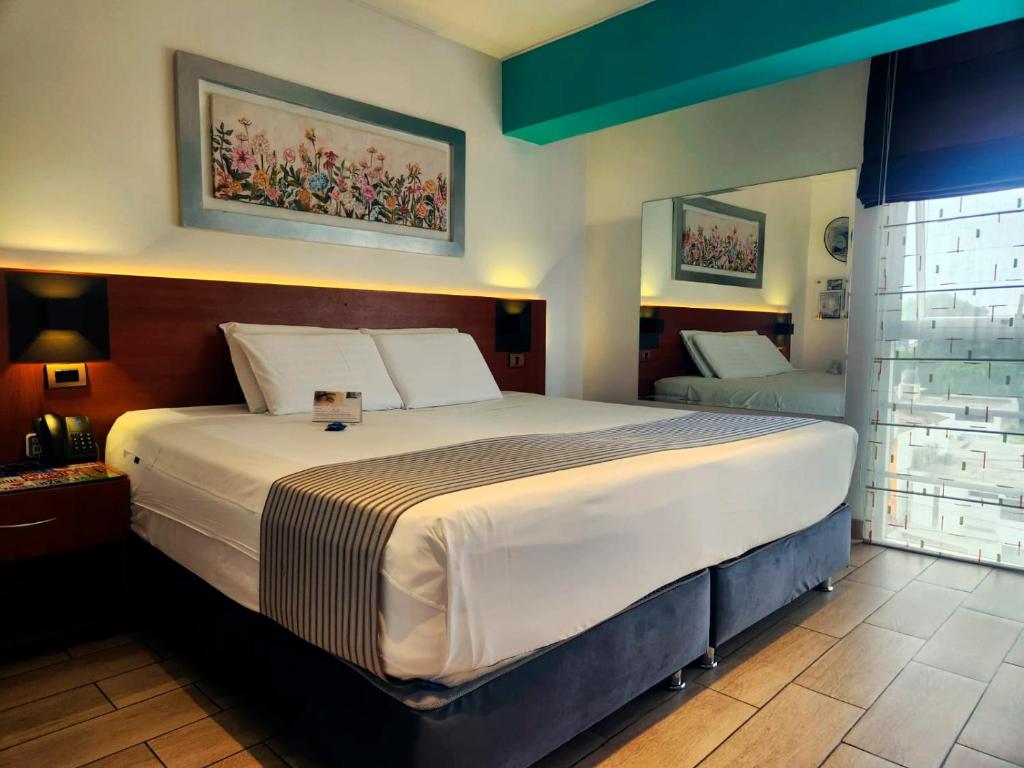 a bedroom with a large bed in a room at Hotel Vila Santa in Lima