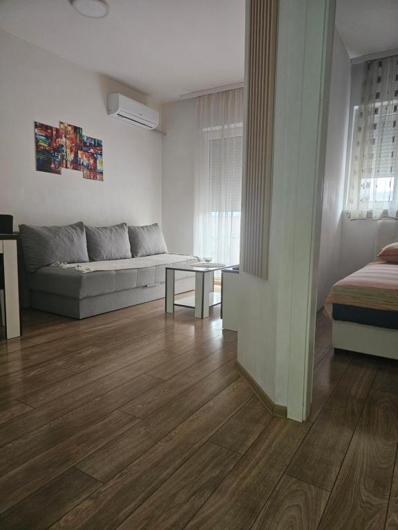 a living room with a couch and a table at Apartman Borko 2-1 in Loznica