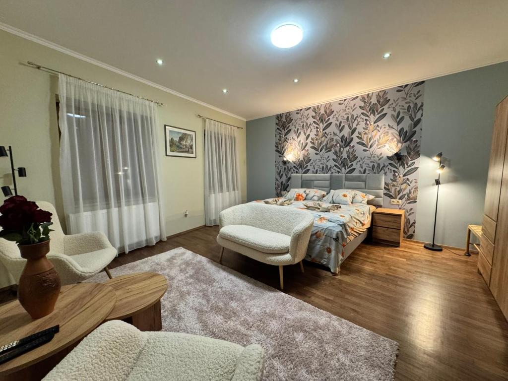 a bedroom with a bed and a living room at Tessa Central House in Kőszeg