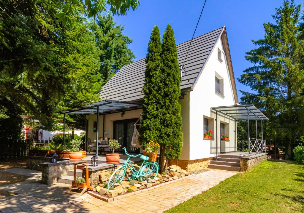 a white house with a black roof at Jázmin Chill Cottage in Bánk