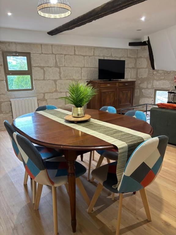 a dining room with a wooden table and chairs at gite 3 le havre in Aubeterre-sur-Dronne