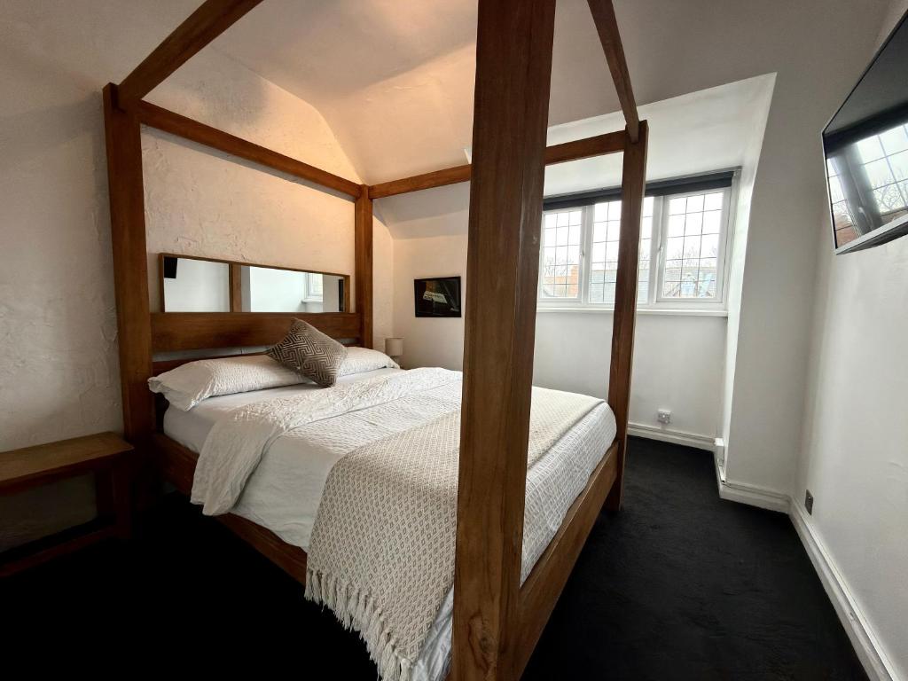 a bedroom with two beds and two windows at One-Bedroom flat in Cheam Village in Cheam