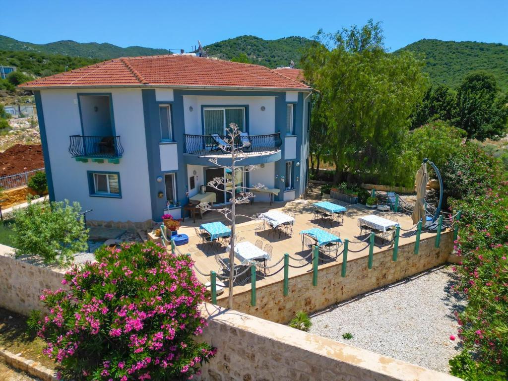 a villa with a view of a patio and a house at Lacitrus Hotel & Villa in Kaş