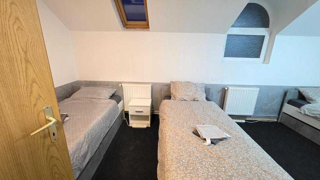 a room with two beds and a door open at Casa El Gringo in Tîrnăveni