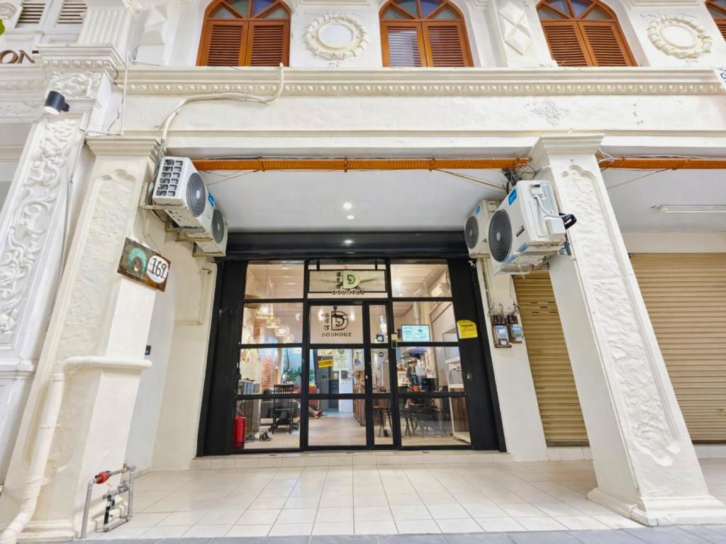 an entrance to a building with a revolving door at Dou Houz Georgetown in George Town