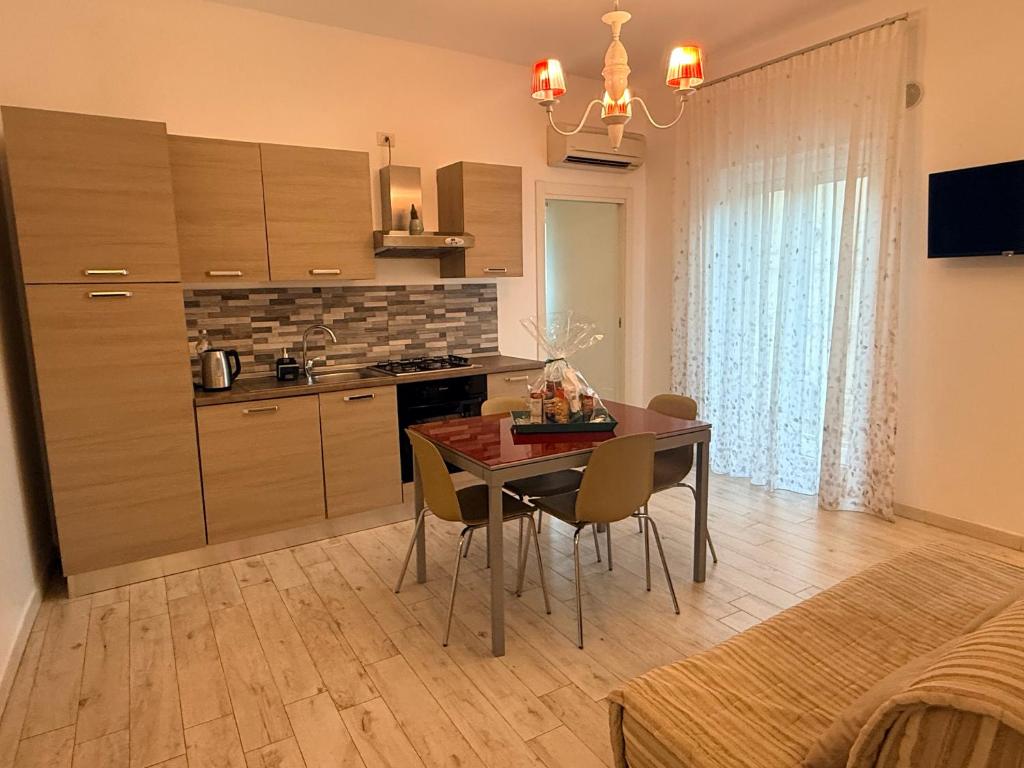 a kitchen with a table and chairs in a room at Casa Vacanze De Nittis - Meridia Collection in Barletta