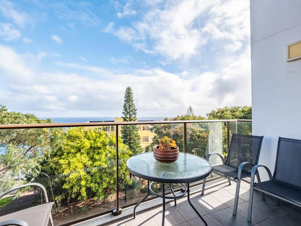 a patio with a table and chairs on a balcony at Tamariz Flat in Santa Cruz