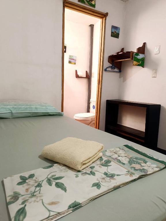 a bedroom with a bed with a towel on it at Casa de Los Berrios in León