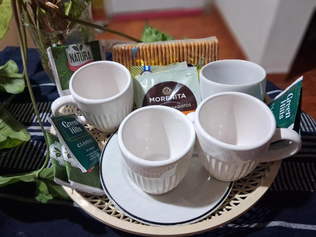 three cups on a plate on a table at Apart Sur Catriel in Catriel