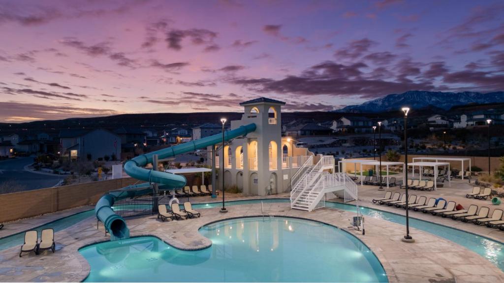 a swimming pool at a resort with a water slide at Pool, lazy river, pickle ball, sleeps 14, fire pit in Washington