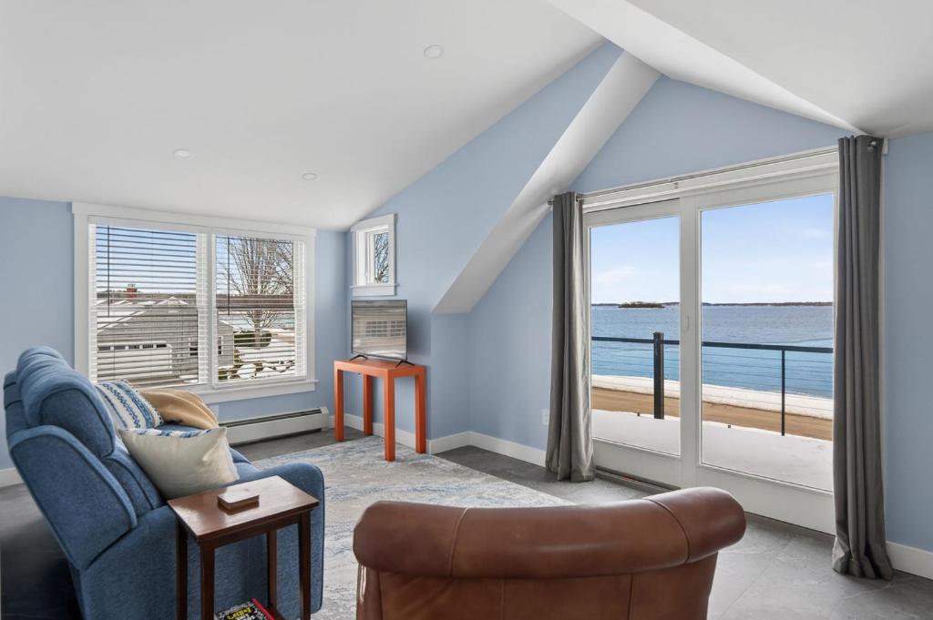 a living room with a view of the ocean at Modern Waterfront Apt with Bay Views in Falmouth