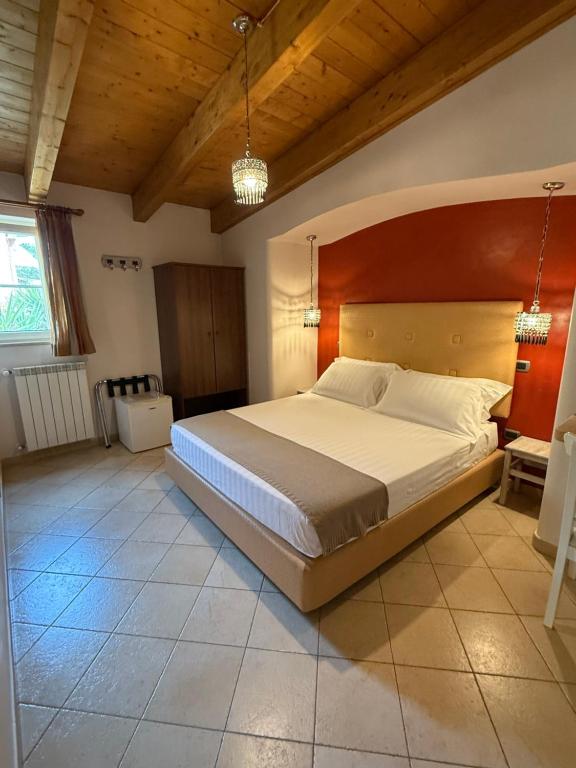 a bedroom with a large bed with a wooden headboard at Bed & Breakfast De Nittis - Meridia Collection in Barletta