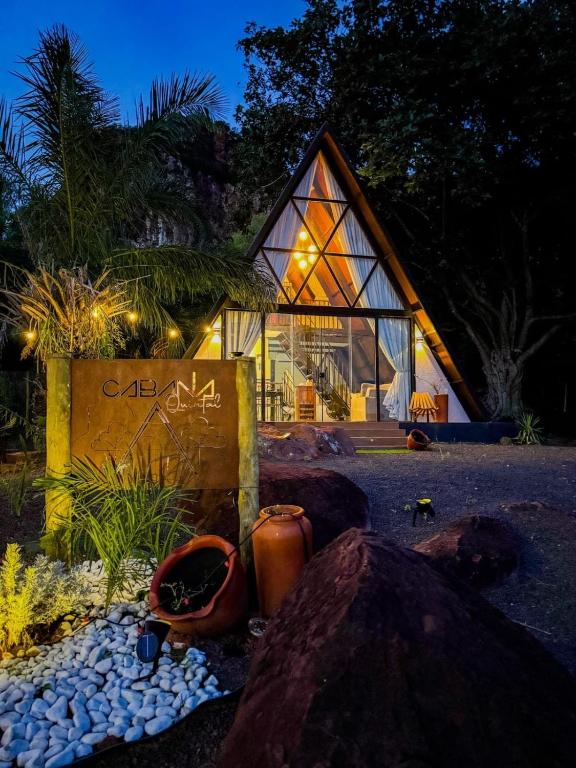a building with a sign in front of it at night at Cabana Quintal in Aquidauana