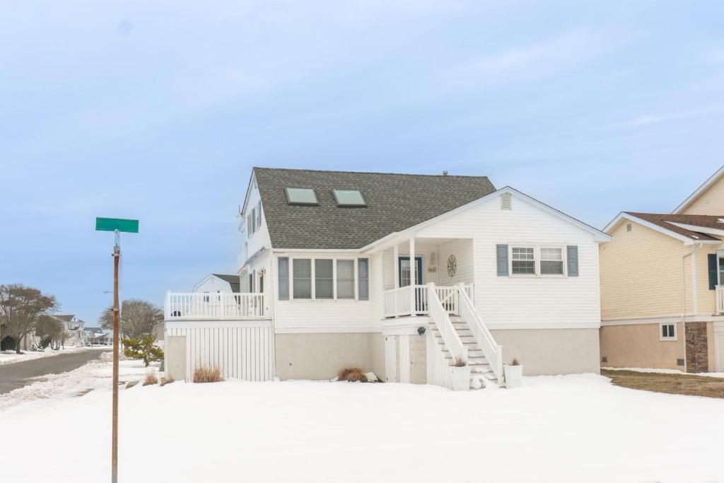 a white house with snow in front of it at Ocean City 2BR Condo in Ocean City