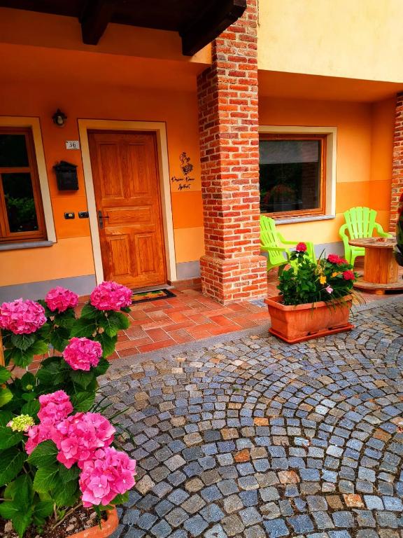 a house with pink flowers in front of a door at Passione Peonie Apartment in Roccabruna