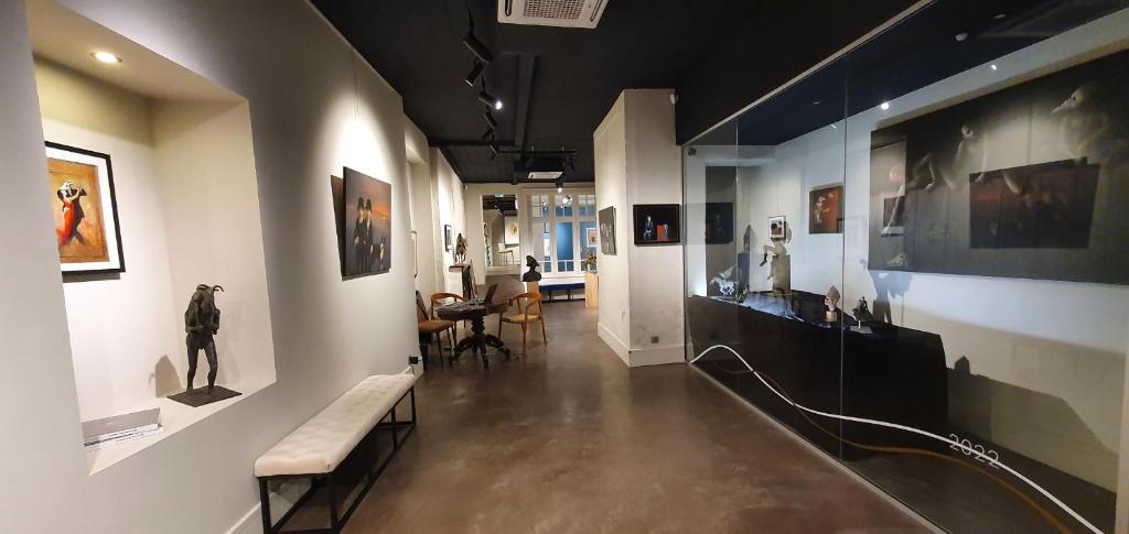 a hallway with a bunch of art on the walls at Maison PARAGONE in Bergues