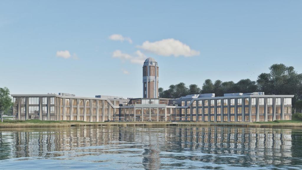 a large building next to a body of water at Postillion Hotel Breda Biesbosch in Raamsdonksveer