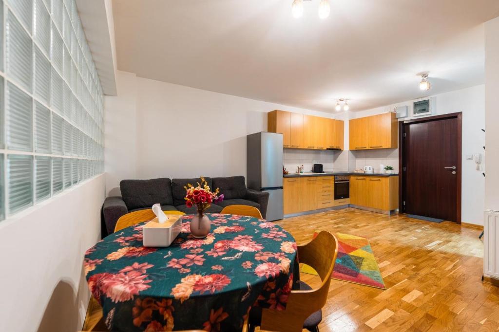 a living room with a table and a kitchen at Yvett Studio-Fortuna Park in Sfântu-Gheorghe