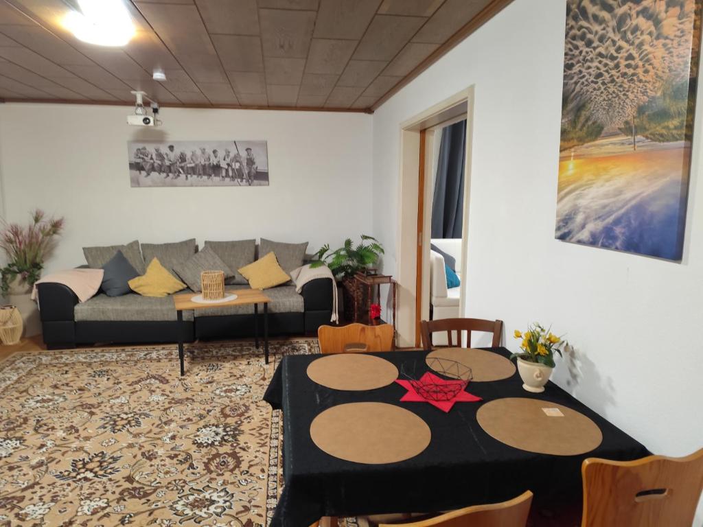a living room with a table and a couch at Haus - Baden-Baden - 8x Zimmer in Sandweier