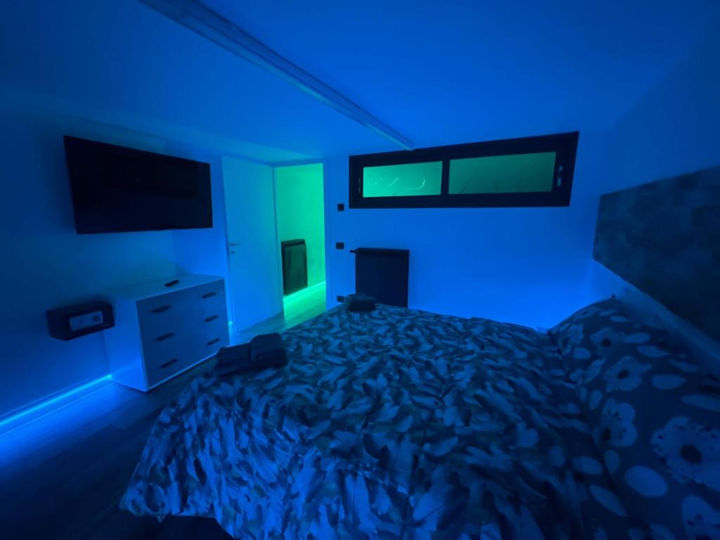 a bedroom with a bed with blue lights on it at Mini Suite Apartment 2 in Castel di Sangro
