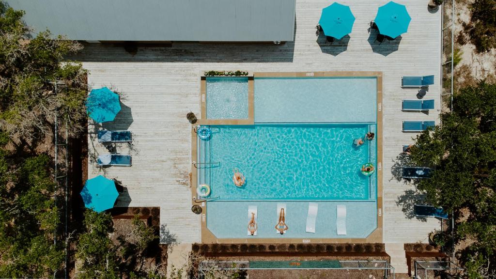 an overhead view of a swimming pool with chairs at Lucky Arrow Retreat in Dripping Springs