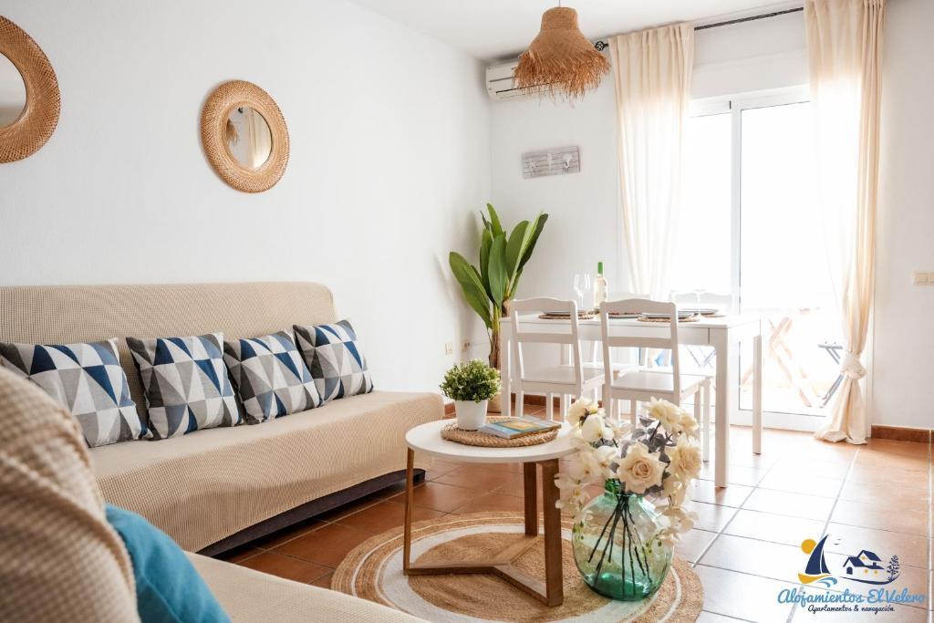 a living room with a couch and a table at El Velero - Vacaciones inolvidables frente el MAR in San José