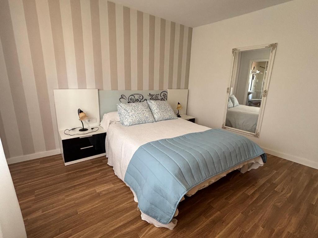 a bedroom with a bed and a large mirror at Torkes in Foz