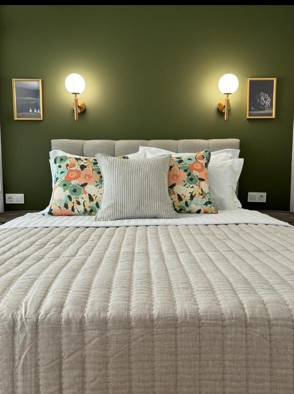 a bedroom with a large white bed with two pillows at Atelie Home Experience 2 in Serres