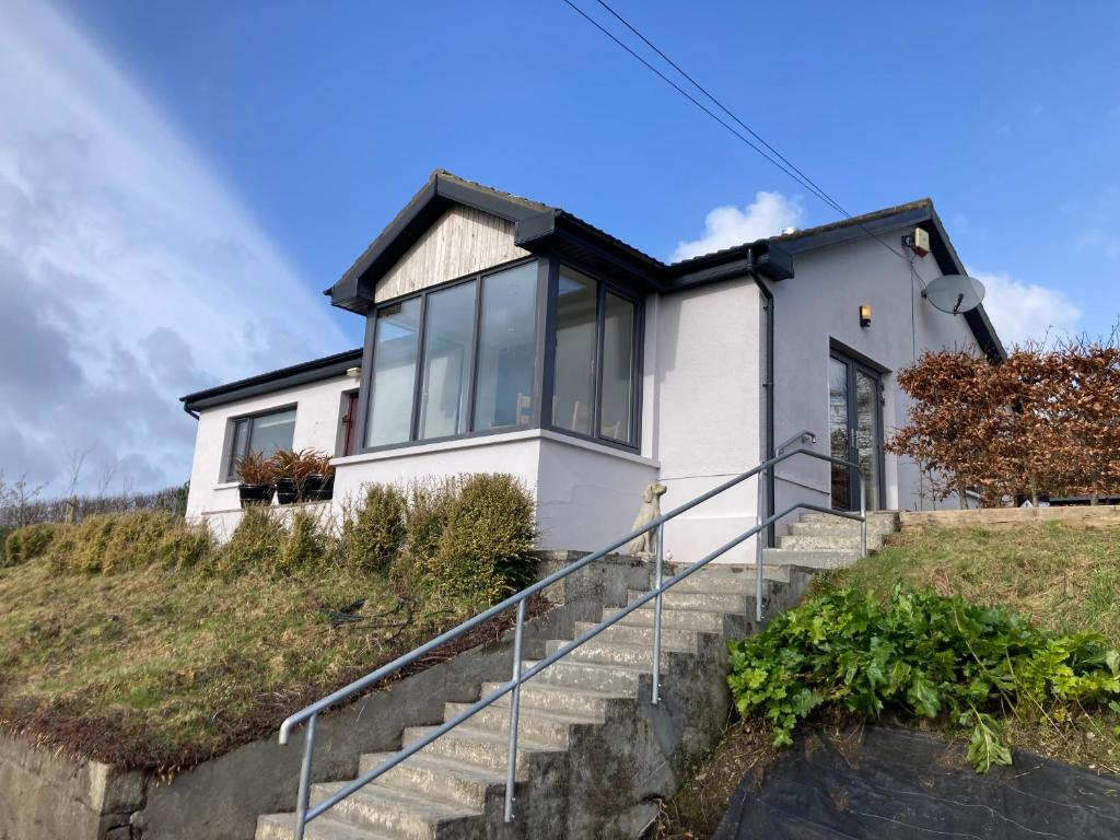 a white house on a hill with stairs at Ocean View in Rosscarbery