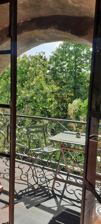 a table and chairs on a balcony with trees at A Toca, Complete townhouse apartment in Monchique