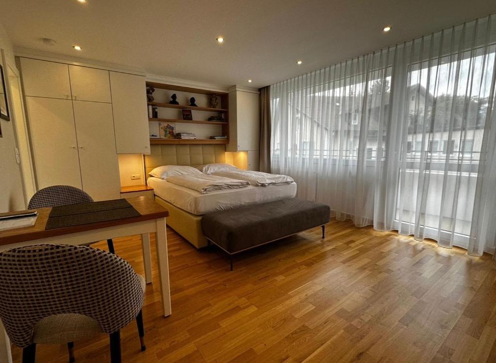 a bedroom with a bed and a table and chairs at Zum Franziskaner Dependance in Füssen