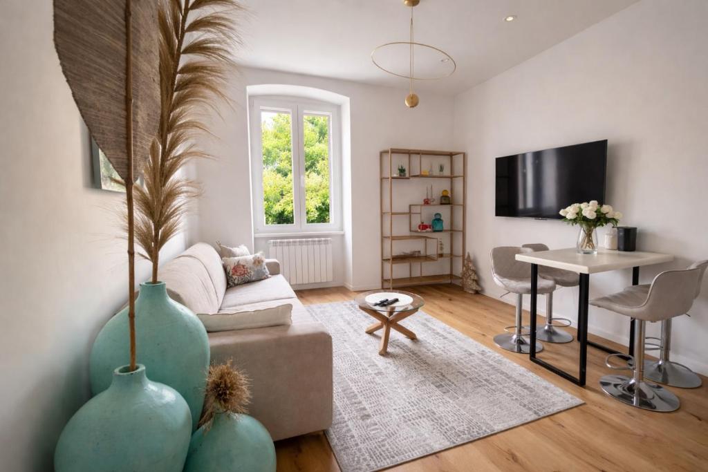 a living room with a couch and a table at Boutique Apartment Trieste in Trieste