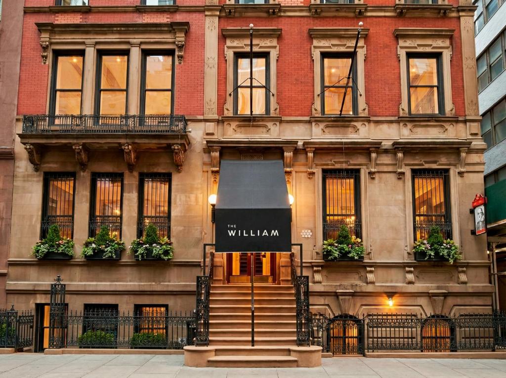 a building with a sign on the front of it at The William Hotel Midtown, New York in New York