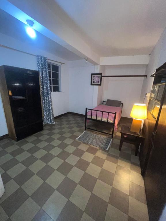 a room with a bed and a table and a lamp at Tourist Rendez Vous Hotel in Plaine Magnien
