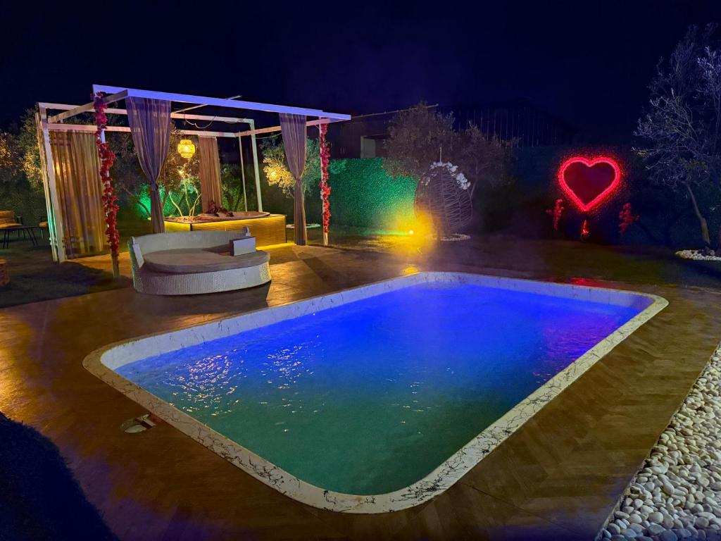 a swimming pool in a backyard at night at ON2 Bungalov Villas in Dosemealti