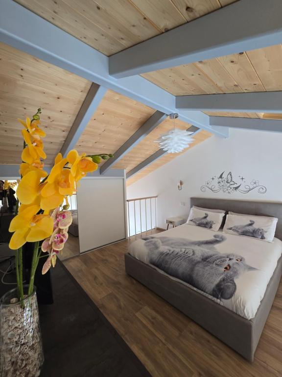 a bedroom with a bed and flowers in a vase at marinella house 2 in Sarzana