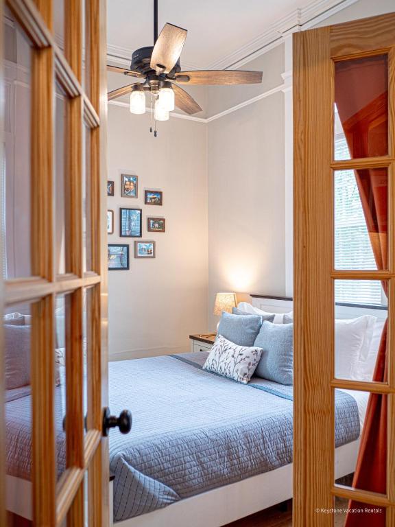 a bedroom with a bed and a ceiling fan at Oak and Ember at Marietta Square in Marietta