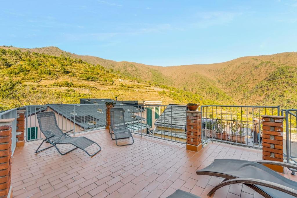 a balcony with chairs and a view of a mountain at Sea Whisper Volastra in Volastra