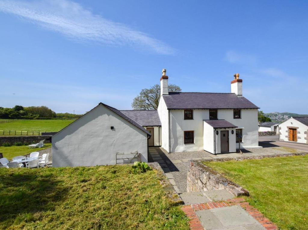 a large white house with a grassy yard at 4 Bed in Llandudno Junction oc-58301 in Llandudno Junction