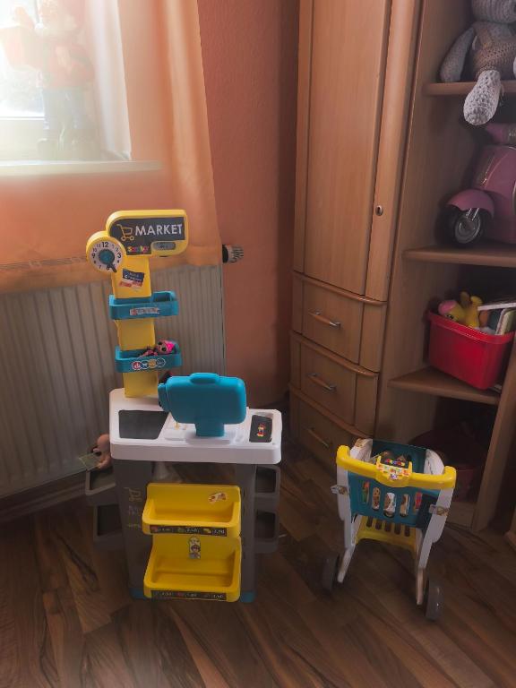 a toy kitchen with a sink and a chair at Diana Apartments in Klingenthal