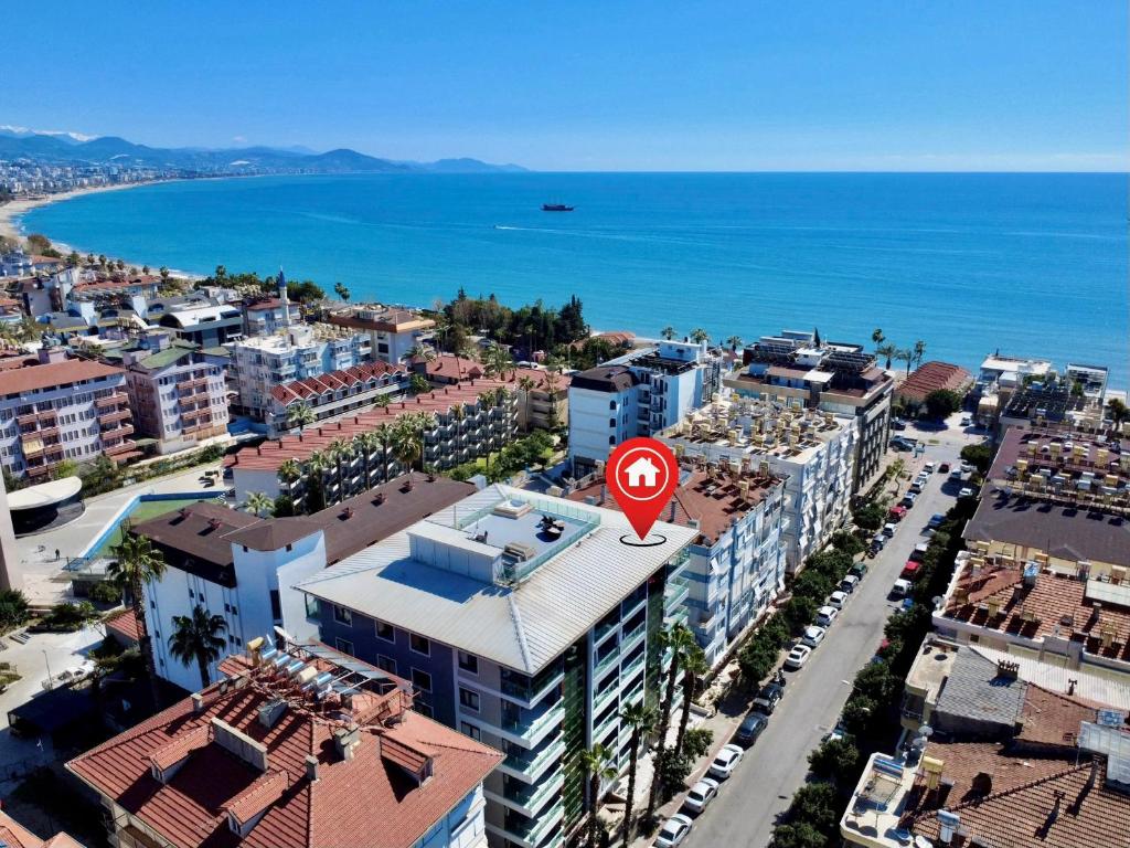 a city with a red sign on top of a building at SA Apartments! Sea View 2BD Flat in Alanya