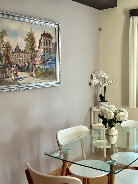 a dining room with a glass table and chairs at Olea House in Elia Laconias