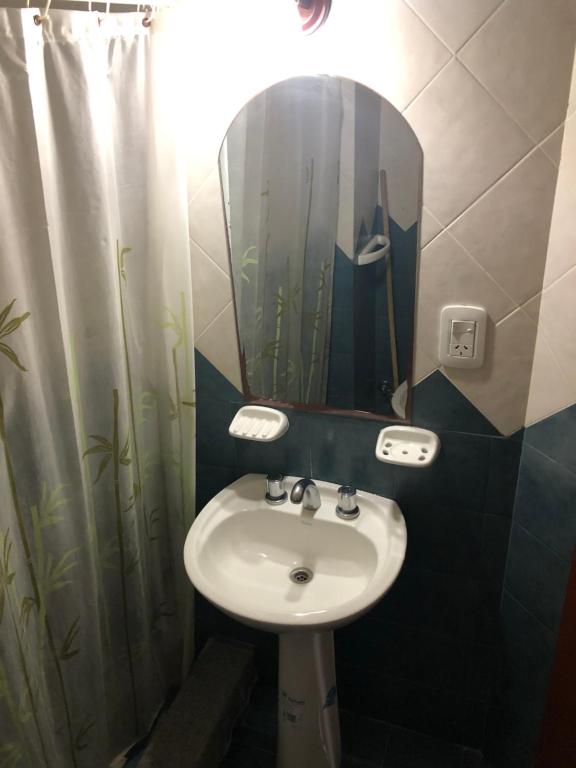 a bathroom with a sink and a mirror at Departamentos Li-Del in Monte Hermoso