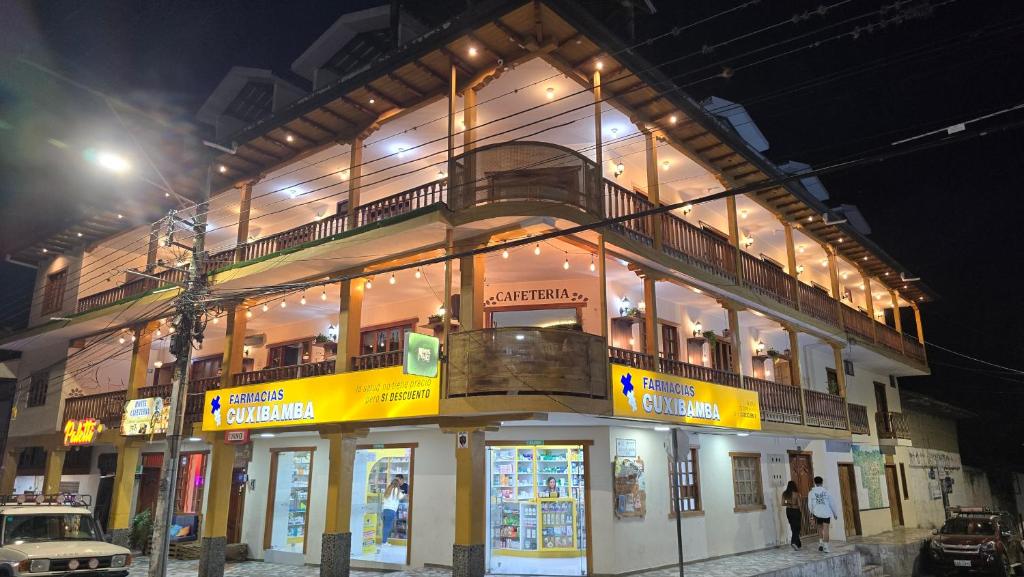 a building with a balcony on top of it at night at Hotel Vilcabamba Eterna Juventud in Vilcabamba