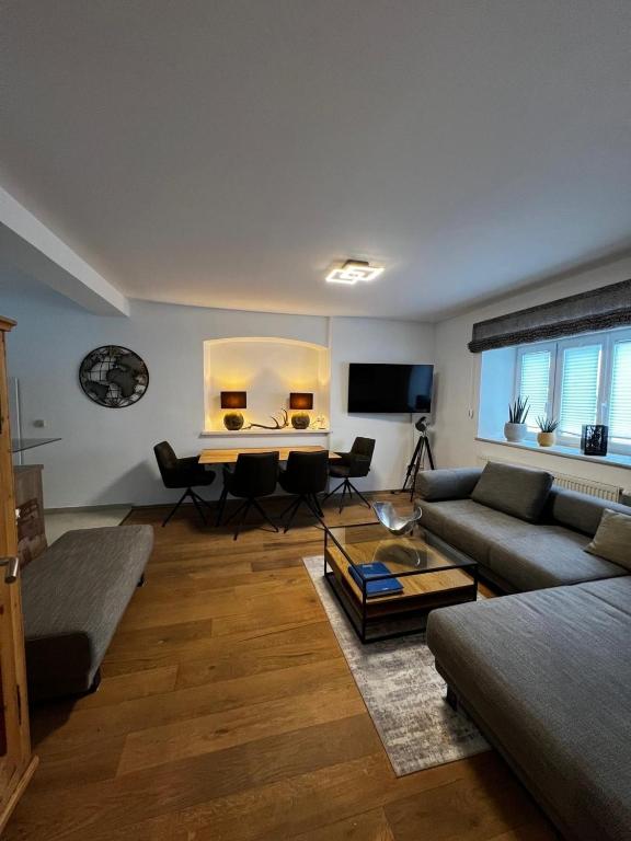 a living room with a couch and a table at Ferienwohnung Rössler in Brannenburg